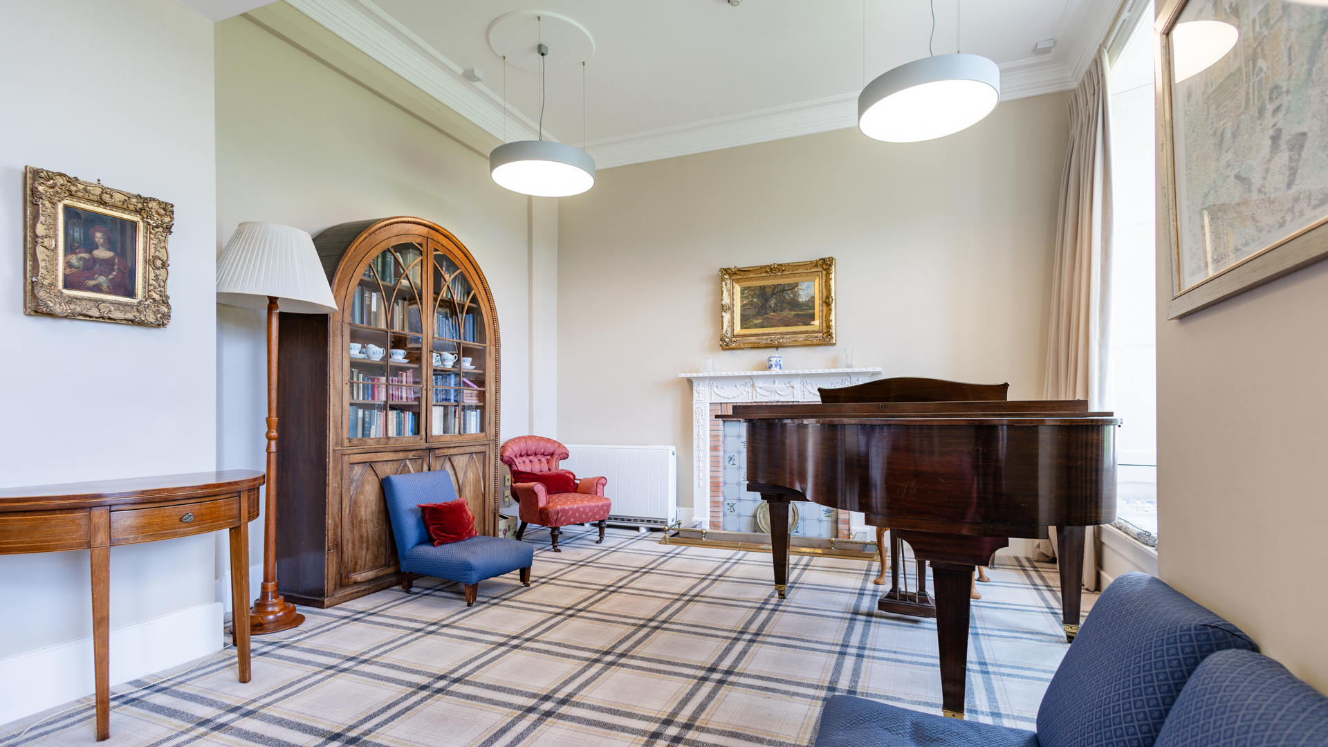 zona comun tranquila de la residencia con libreria y piano en el curso escolar en inglaterra en St. Leonards School